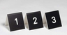 E. Ahlström Table number serial numbers 21-30 black/white, ABS, 5x5x5,5 cm